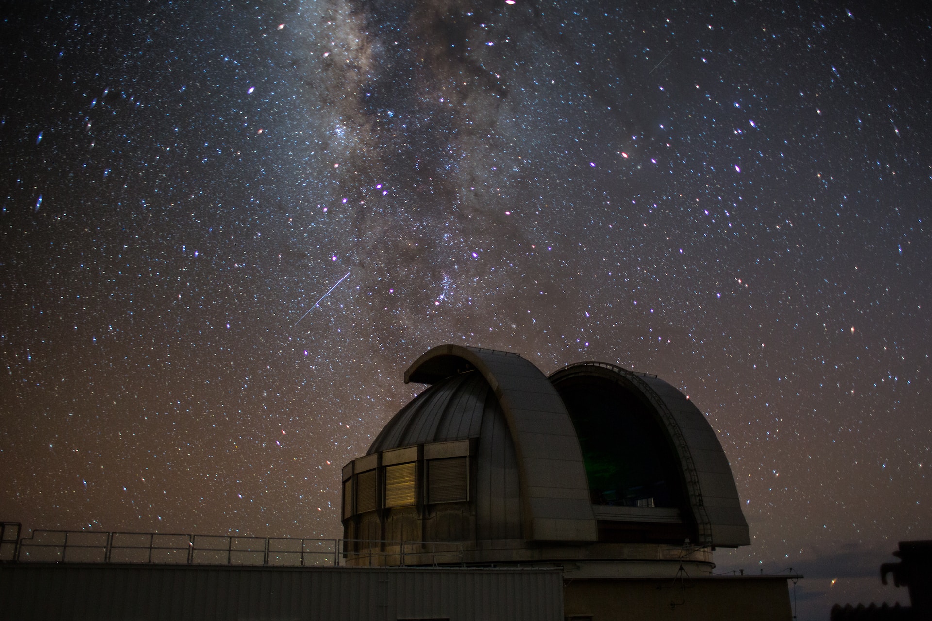 Starry sky in front of Mauna Kea Observatory.